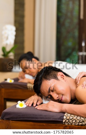 Indonesian Asian couple man and woman in wellness beauty spa having aroma therapy massage with essential oil, looking relaxed