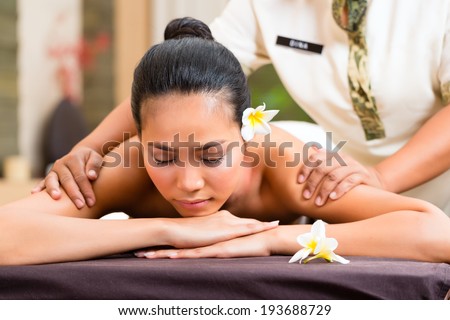 Indonesian Asian woman in wellness beauty day spa having aroma therapy massage with essential oil, looking relaxed