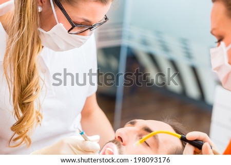 Patient having dental deep tooth cleaning at dentist