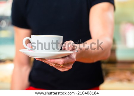 Waiter working in ice cream parlor or cafe serving coffee