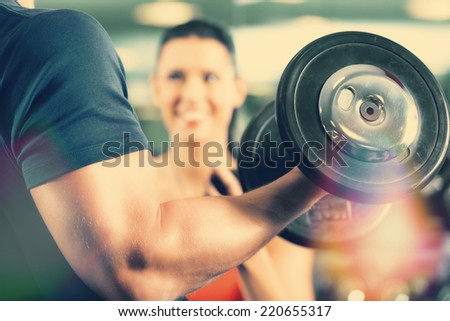 Man or Bodybuilder with his personal fitness trainer in the gym exercising sport with dumbbells, closeup Stock foto © 