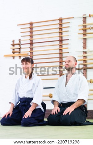 Man and woman at Aikido training in martial arts school