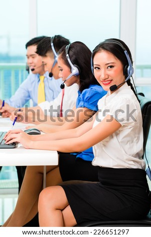 Asian Chinese call center agent team on phone