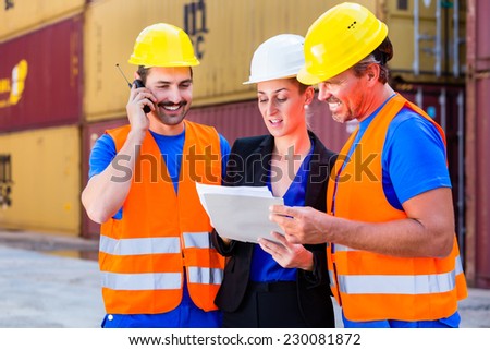 Worker and manager of shipment company discussing freight or shipment documents, one man is using phone or walkie-talkie