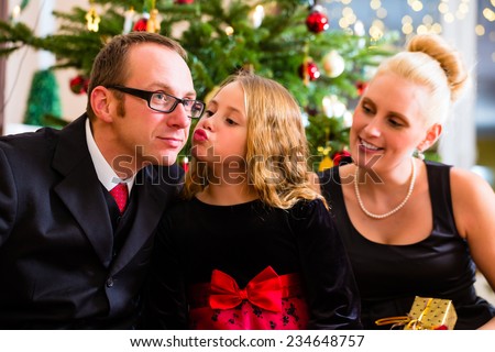 Parents and daughter with Christmas gifts