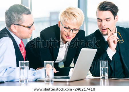 Business - meeting in office, the businesspeople with boss and team are discussing a document on Laptop computer