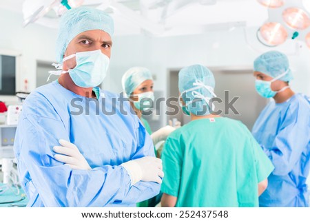 Hospital - surgery team in the operating room or Op of a clinic operating on a patient, perhaps it\'s an emergency