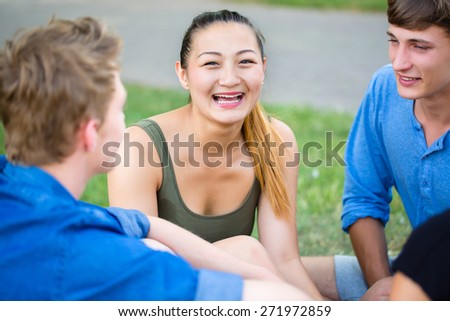 Student in park talking having picnic at river
