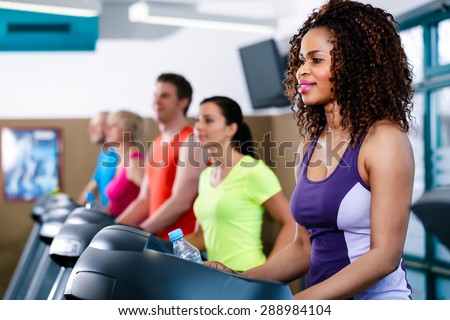 Diversity group of young and senior, Caucasian and black people on treadmill in gym