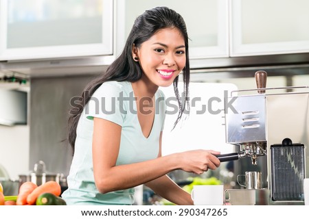Asian woman or girl making espresso coffee in his kitchen