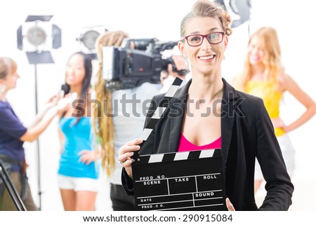 Woman with take clap or board on Film Set of video production for TV, television, news or commercial