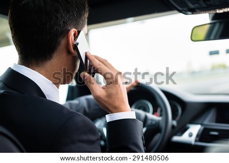 Man using his phone while driving the car