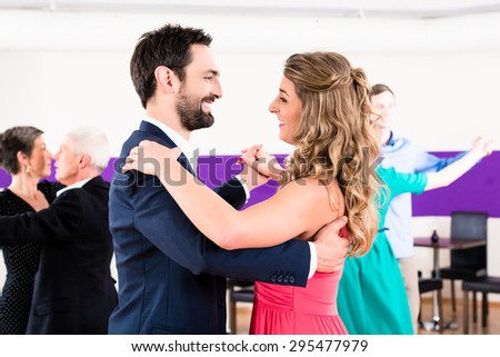 Young and senior couples getting dance lessons