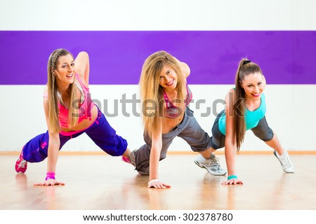 Young zumba women dancing modern group choreography in dance school