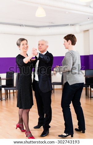 Dance instructor with senior couple of woman and man