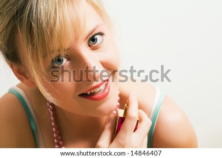 Beautiful woman using perfume and enjoying it visibly