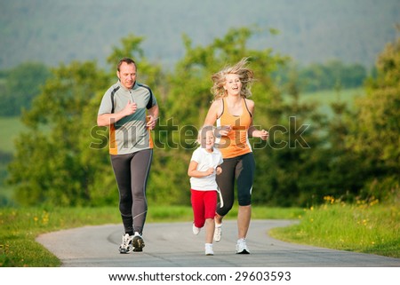 Family jogging outdoors with the kid