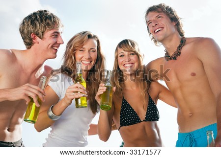 Group of very beautiful people celebrating on the beach in the summer of their lives - focus on faces