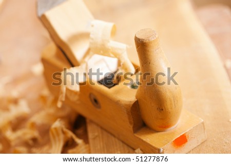 Used wood planer in the workshop of a carpenter with shavings of wood, standing on a workbench