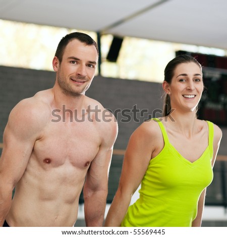 Sportive couple does some training on the high bar together