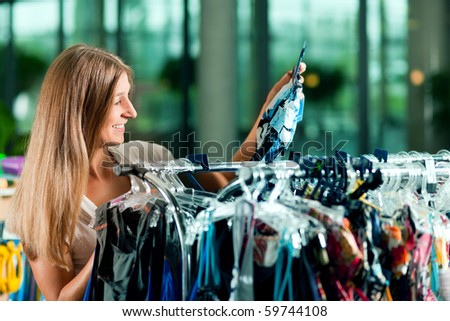 Woman browsing through clothes on a rack in a fashion store
