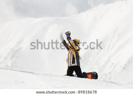 Snowboarder in the snow in winter, probably he is waiting for somebody