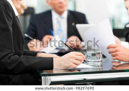 Business - meeting in an office, lawyers or attorneys discussing a document or contract agreement