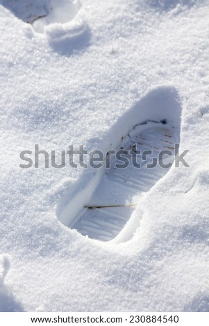 Closeup of footsteps in snow going forward