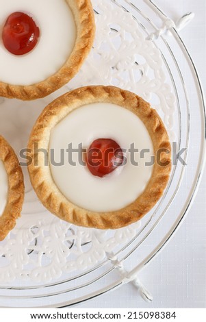 Cherry Bakewell tart a frangipane pastry covered in almond icing and a half cherry on top