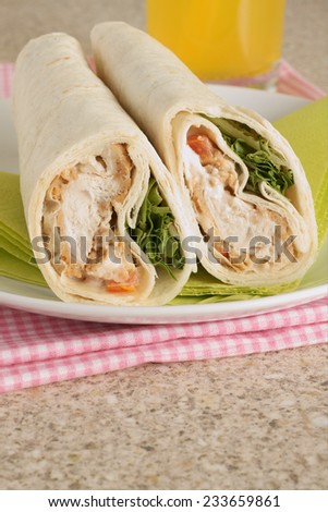 Chicken salad tortilla wraps made with breaded chicken lettuce and tomato