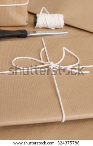 Parcel packing with brown parcel paper and string