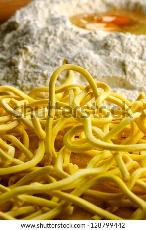 Homemade fresh pasta, italian spaghetti alla chitarra with ingredients and tools