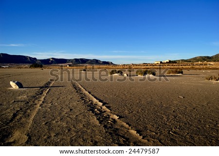 Climate change, global warming effect: dry salt lake. - desert landscape, tyre tracks detail (Spain)