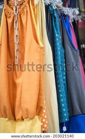 clothes on a rack on a flea market.