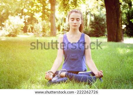 beautiful teenage girl meditates in nature