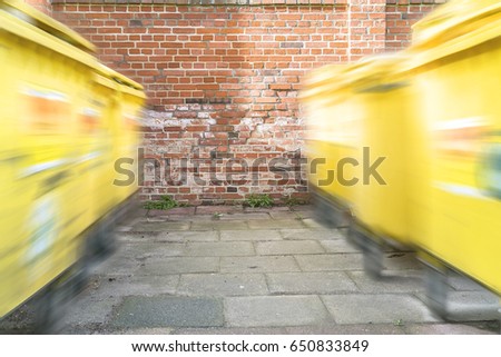 Similar – Image, Stock Photo moving yellow dumpster in front of a red brick wall