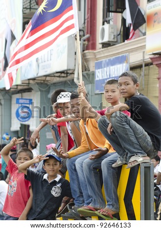 PAHANG, MALAYSIA - SEP 16 : Unidentified children celebrate the National Day and Malaysia Day parade, celebrating 54th anniversary of independence on September 16, 2011 in Kuatan, Pahang, Malaysia