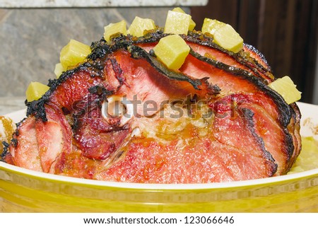 Baked Spiral Cut Honey Bone In Ham with Cloves and Pineapple Chunk Closeup
