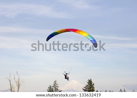 Paragliding Over Mount Hood with Rainbow Colored Parachute