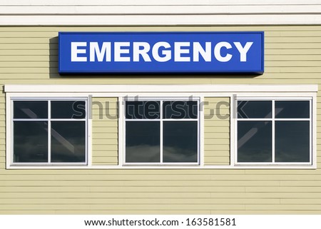 Emergency Sign Above Windows Outside Hospital or Emergency Clinic Building