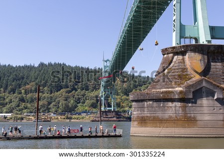 PORTLAND, OREGON - JULY 29, 2015: Greenpeace USA activists rappelled off St Johns Bridge in Portland OR protest of Shell Oil Icebreaker Ship leaving for oil drilling in Arctic onlookers and supporters