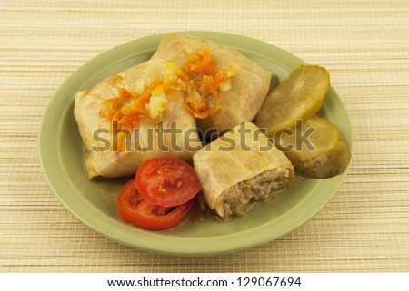 stuffed cabbage with tomatoes and cucumbers  in ceramic plate