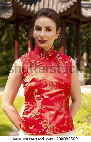 Beautiful girl in red chinese traditional clothes (qipao)