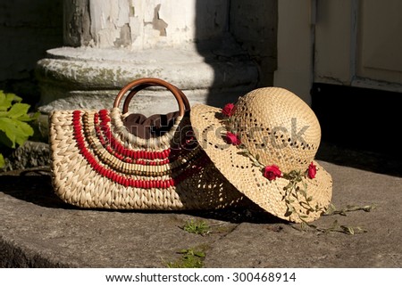 still life with straw hat and bag