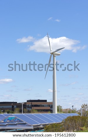 Photovoltaic solar panels of ground level solar array and power generating wind turbine