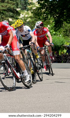 STILLWATER, MN/USA - JUNE 21, 2015: Pro cyclist Neal Shepherd (center) of team Colorado Collective in peloton at stage six of prestigious 2015 North Star Grand Prix pro cycling event in Stillwater.