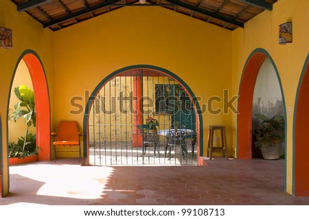 Covered patio of Villa Lourdes with arches and gated entrance