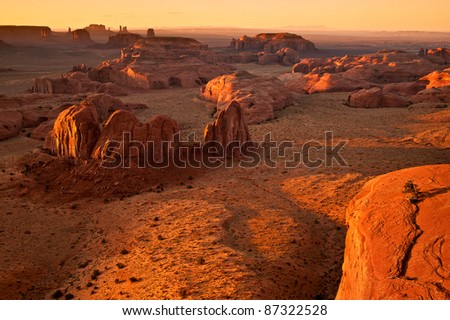 View from Hunt\'s Mesa overlooking Monument Valley at sunset.