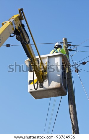 A Telecom/Electrical Engineer using a Mobile Elevating Work Platform Machine.