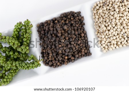 Hot and Spicy Black, White and Green Pepper on white background